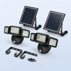 Two solar flood lights with mounting brackets and screws
